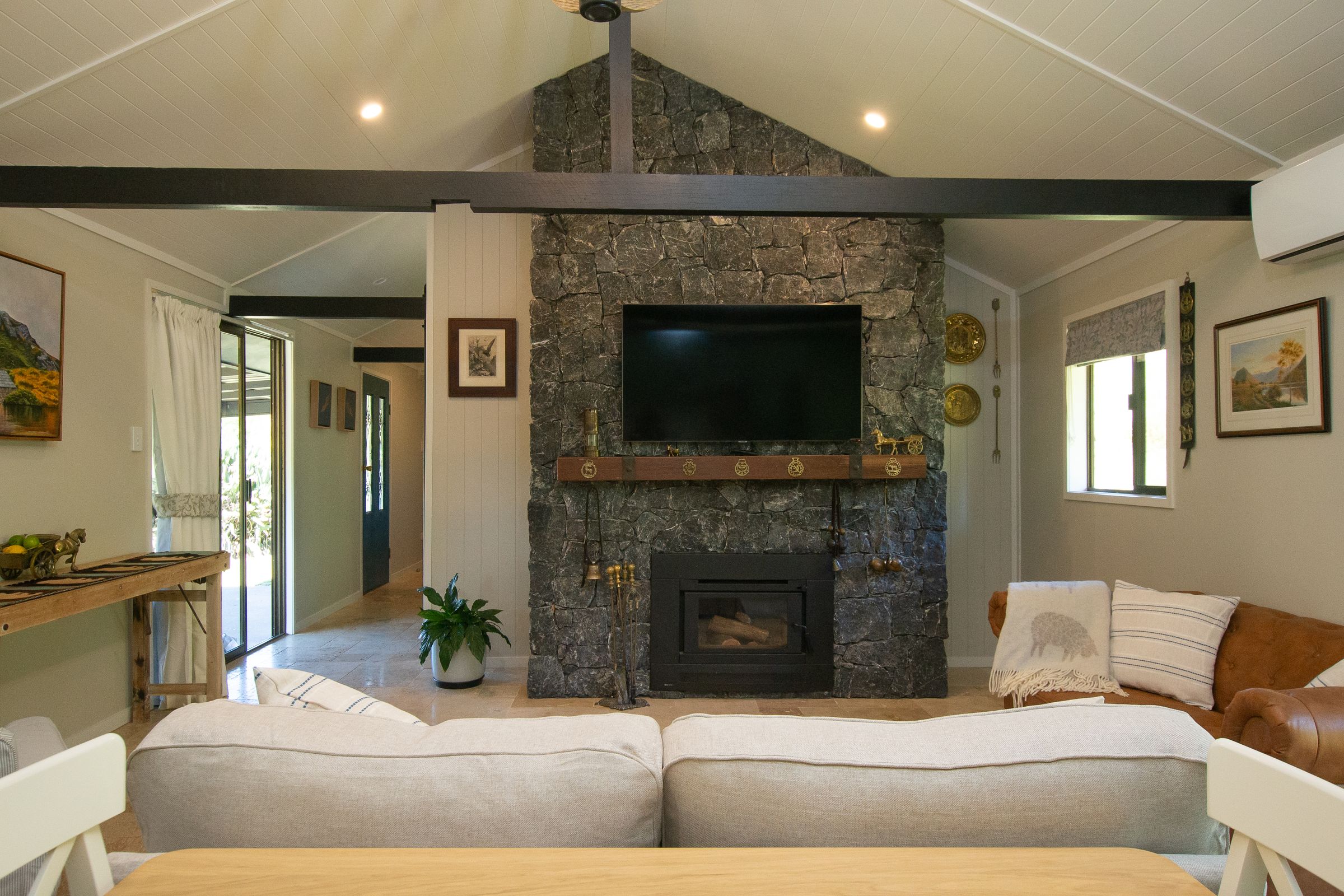 The hand-built black-stone fireplace at the heart of Ceffyl Cottage